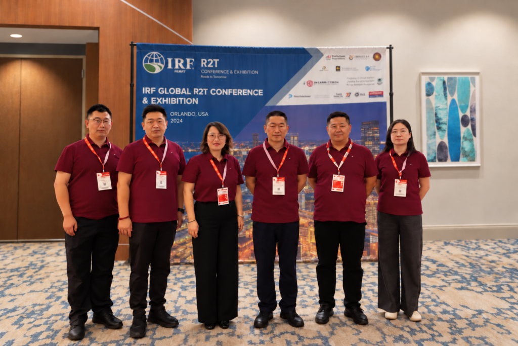 Six people in burgundy shirts composited in front of an IRF R2T conference backdrop.